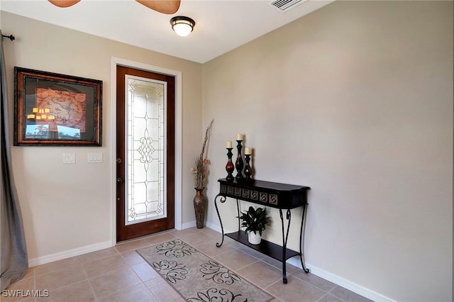 entryway with light tile patterned floors, a wealth of natural light, visible vents, and baseboards