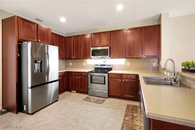 kitchen with light countertops, visible vents, a sink, and appliances with stainless steel finishes