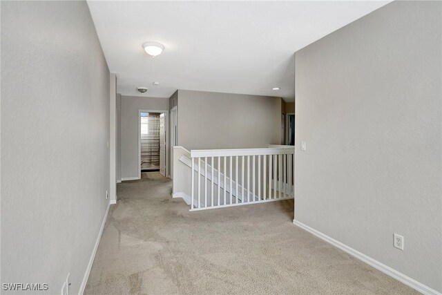 empty room featuring carpet floors and baseboards