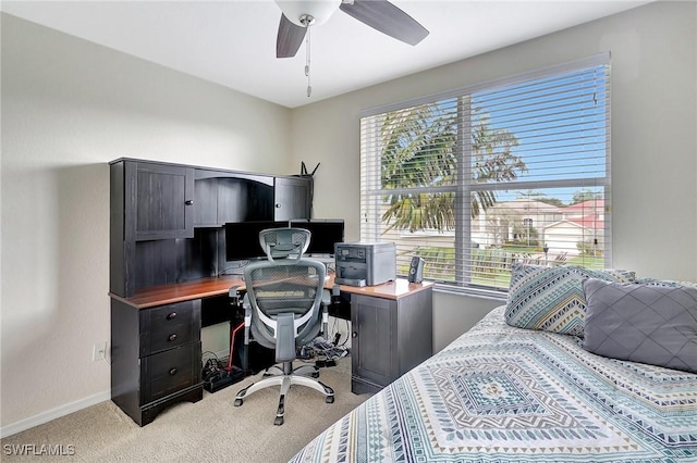 bedroom featuring ceiling fan, baseboards, light colored carpet, and multiple windows