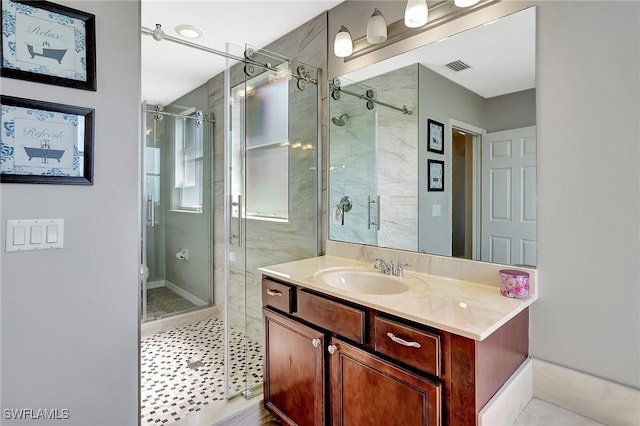 bathroom with vanity, visible vents, a shower stall, and toilet