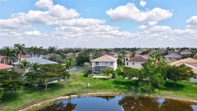 drone / aerial view featuring a residential view and a water view