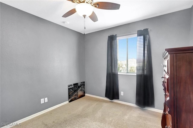 spare room featuring carpet flooring, baseboards, and a ceiling fan