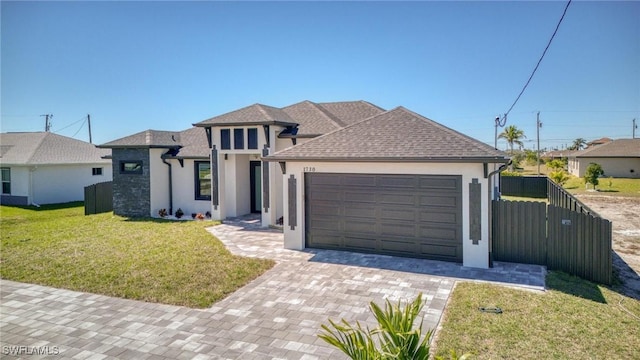 view of front of home with a garage, fence, a front lawn, and stucco siding