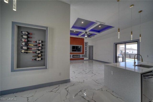 kitchen with coffered ceiling, a sink, baseboards, marble finish floor, and dishwasher