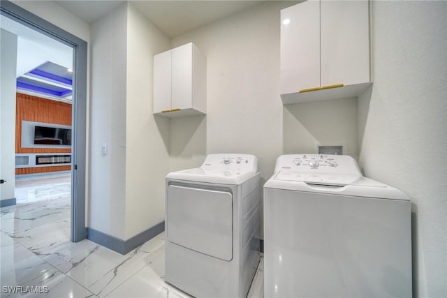 laundry room with marble finish floor, cabinet space, washer and clothes dryer, and baseboards