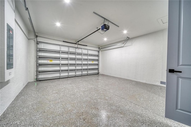 garage featuring a garage door opener, electric panel, and a textured wall