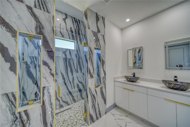 bathroom with marble finish floor, double vanity, a sink, and a marble finish shower