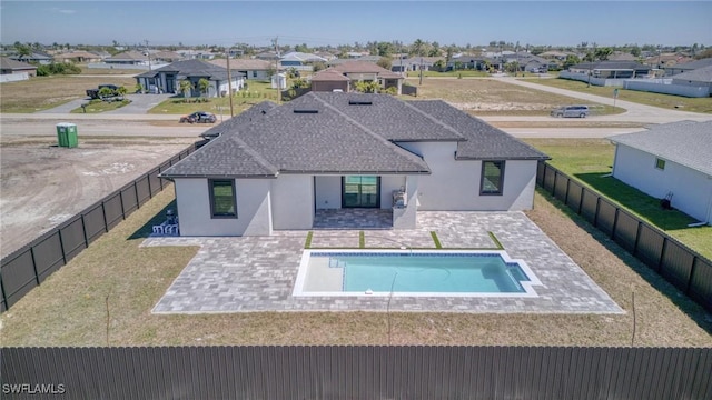 view of pool featuring a residential view, a patio area, and a fenced backyard