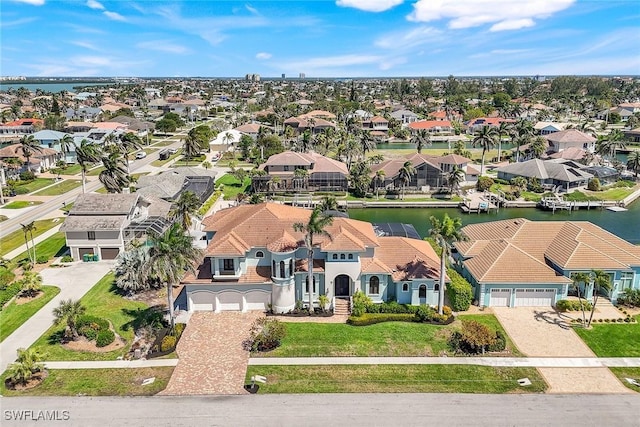 birds eye view of property featuring a residential view and a water view