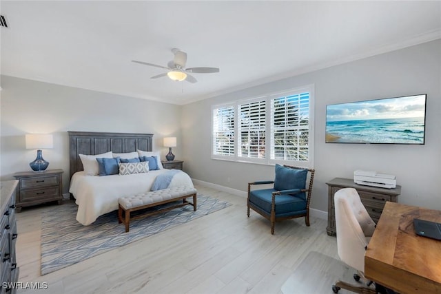 bedroom with light wood-type flooring, visible vents, baseboards, and crown molding