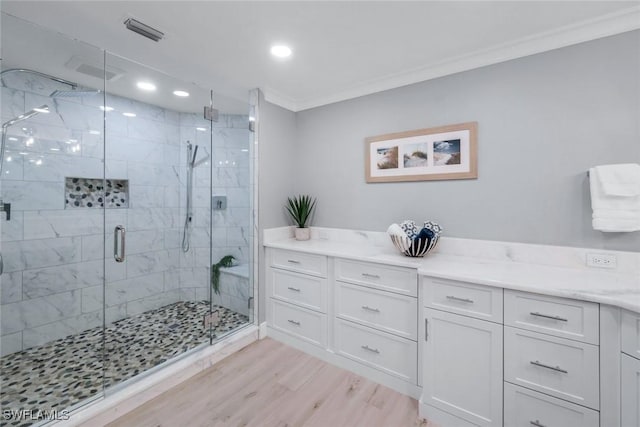 bathroom featuring crown molding, recessed lighting, visible vents, a stall shower, and wood finished floors