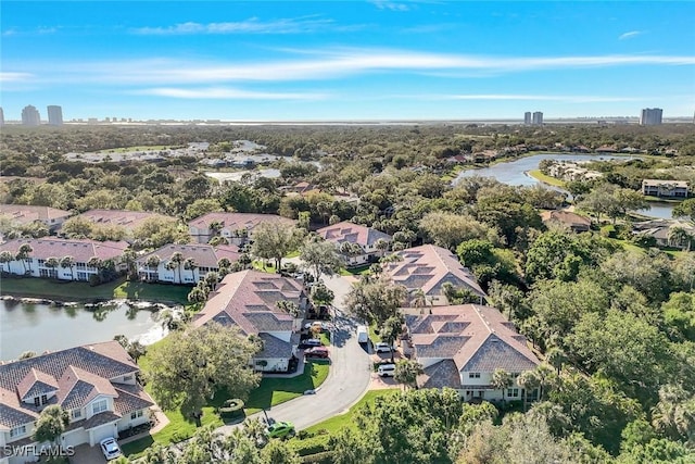 drone / aerial view with a residential view and a water view