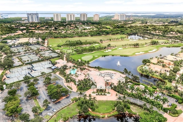 drone / aerial view with view of golf course, a water view, and a city view