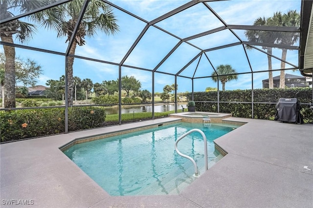 view of swimming pool with a water view, a pool with connected hot tub, a patio, glass enclosure, and a grill