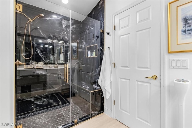 bathroom with a marble finish shower