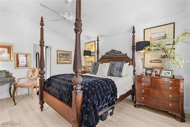 bedroom featuring baseboards, lofted ceiling, ornamental molding, wood finished floors, and a ceiling fan