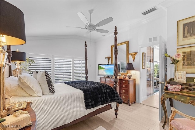 bedroom featuring light wood-type flooring, visible vents, ornamental molding, and vaulted ceiling