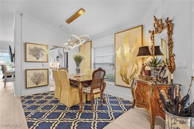 dining space with a wealth of natural light, wood finished floors, crown molding, and vaulted ceiling