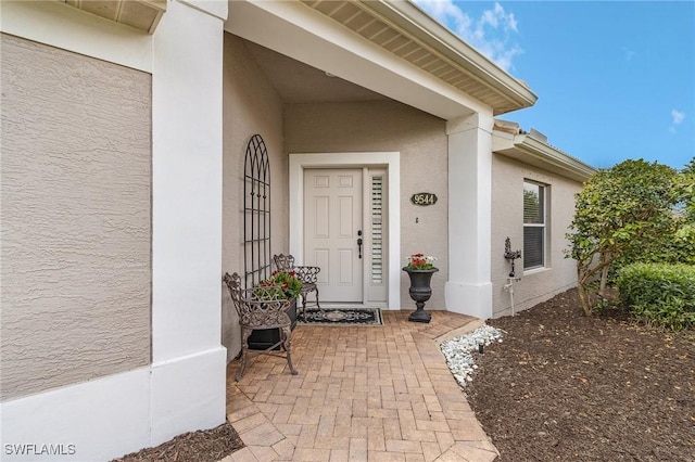 entrance to property with stucco siding