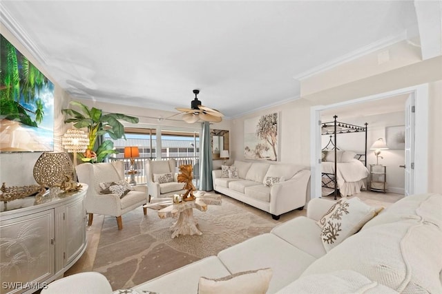 living room with ornamental molding and a ceiling fan