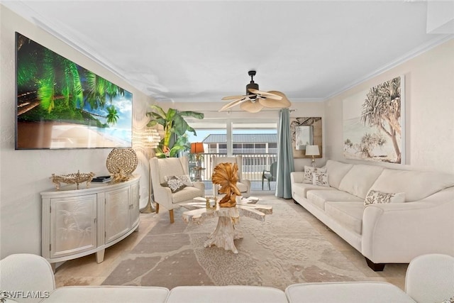 living room with ornamental molding and a ceiling fan