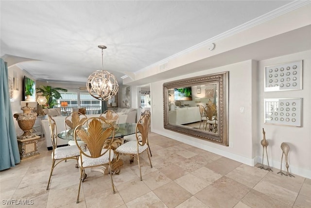 dining area with a notable chandelier, crown molding, and baseboards