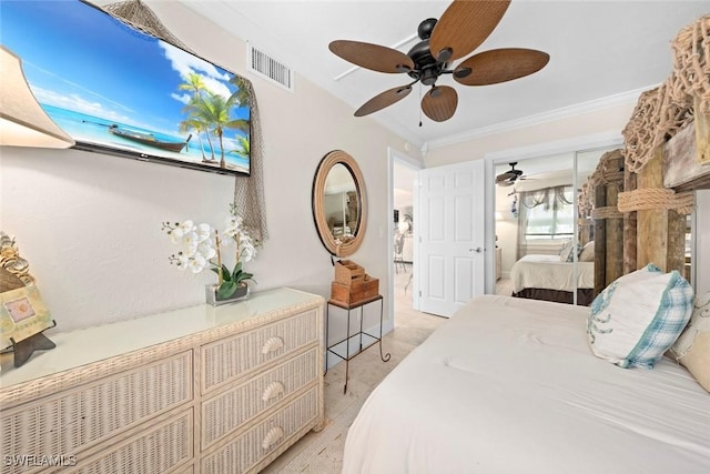 bedroom with a closet, visible vents, a ceiling fan, and ornamental molding