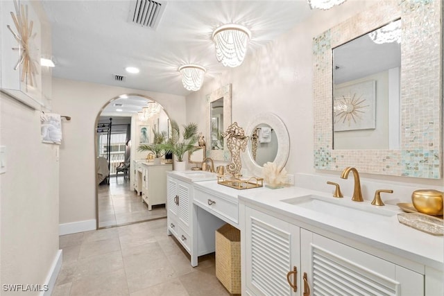 bathroom featuring baseboards, visible vents, ensuite bath, tile patterned flooring, and vanity