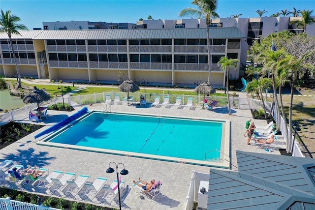 community pool featuring a patio and fence