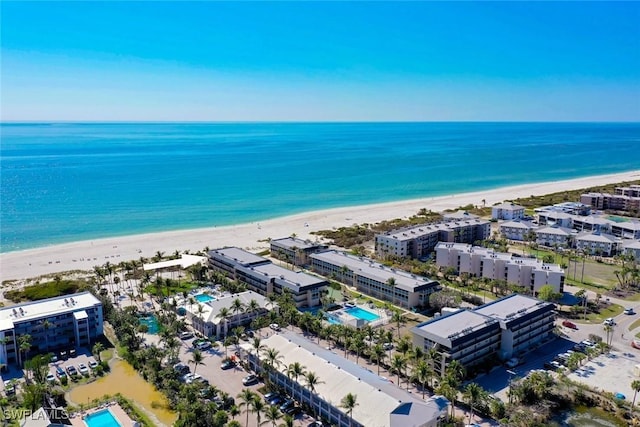 drone / aerial view featuring a water view and a view of the beach