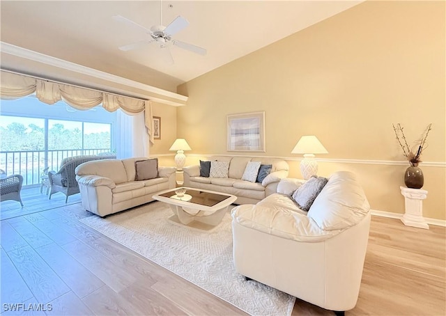 living area with ceiling fan, baseboards, vaulted ceiling, and wood finished floors