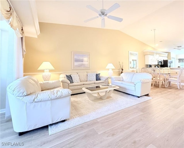 living room featuring ceiling fan, vaulted ceiling, and wood finished floors