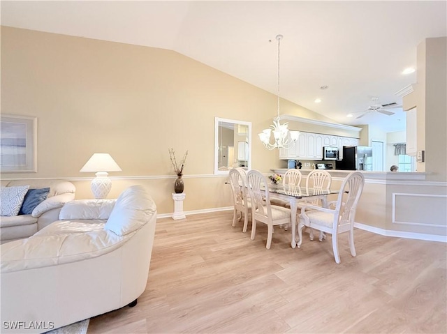 dining space featuring light wood-style floors, lofted ceiling, a chandelier, and baseboards