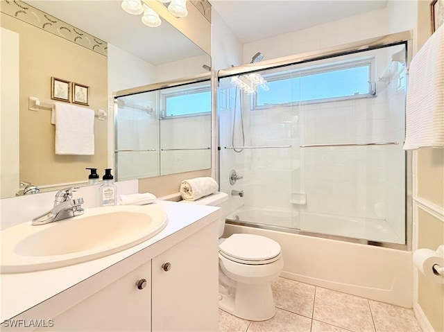 full bathroom featuring a healthy amount of sunlight, vanity, toilet, and tile patterned floors