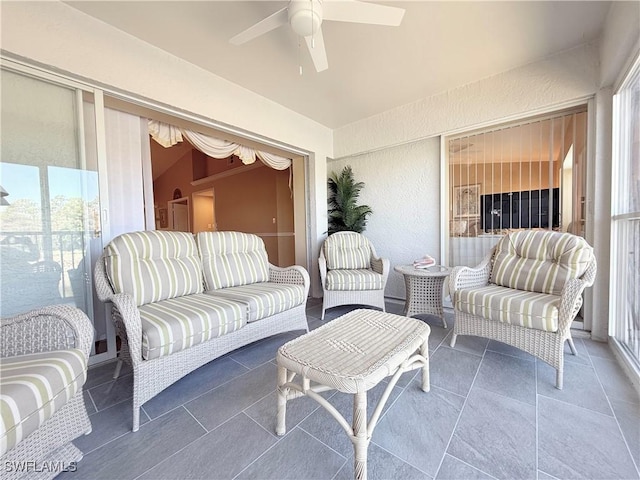 sunroom featuring a ceiling fan