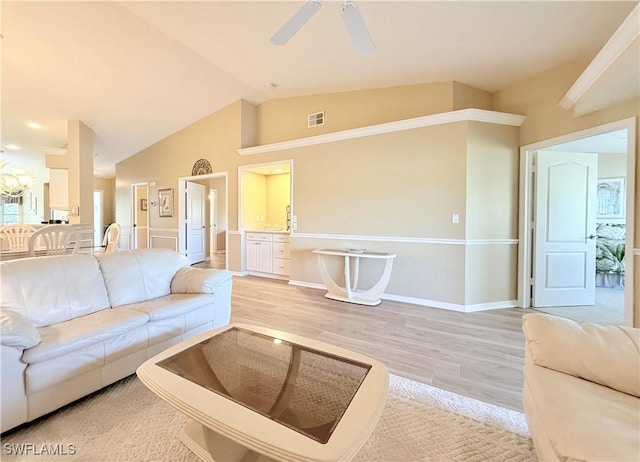 living area featuring visible vents, baseboards, ceiling fan, vaulted ceiling, and light wood-style floors