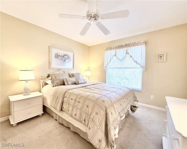 bedroom featuring baseboards, a ceiling fan, and light colored carpet