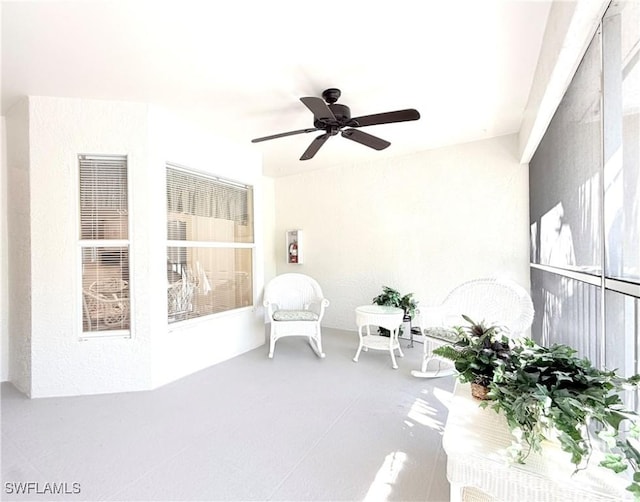 living area with a ceiling fan