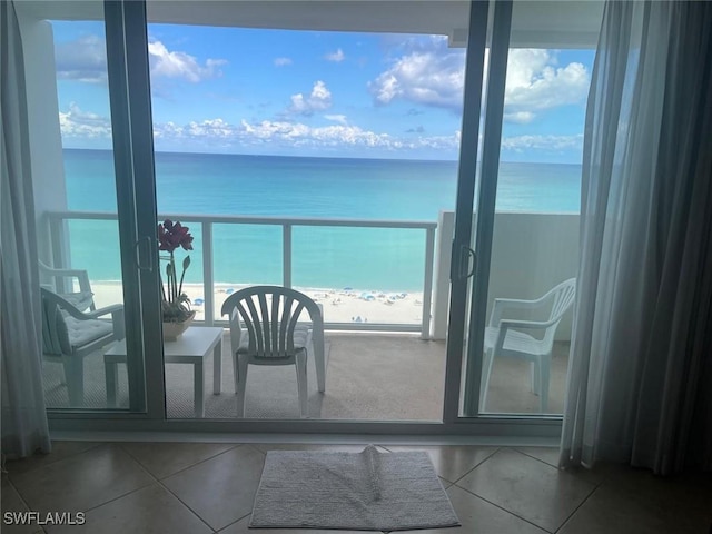 balcony featuring a water view and a view of the beach