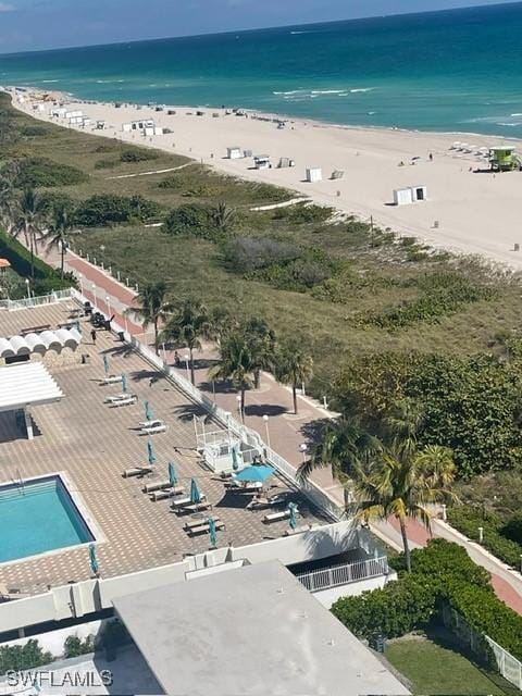 bird's eye view with a water view and a beach view