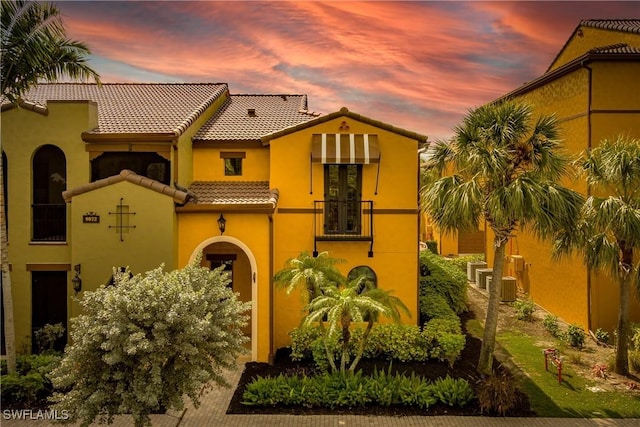 9072 Covina Dr N Unit 5505, Naples, FL 34113 - mediterranean / spanish house with a balcony, a tile roof, stucco siding, and central air condition unit