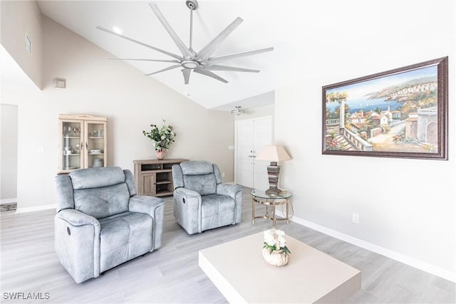 living room featuring visible vents, light wood-style floors, ceiling fan, high vaulted ceiling, and baseboards