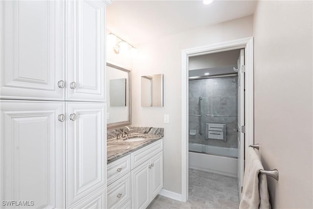 bathroom with shower / bath combination with glass door, vanity, and tile patterned floors