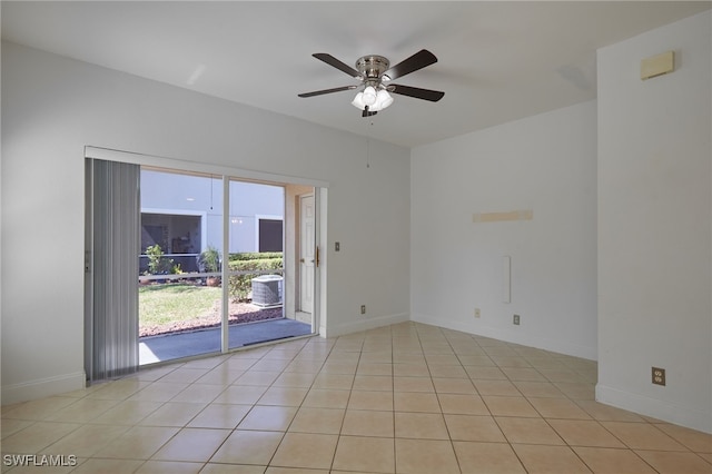 spare room featuring light tile patterned floors, a ceiling fan, and baseboards