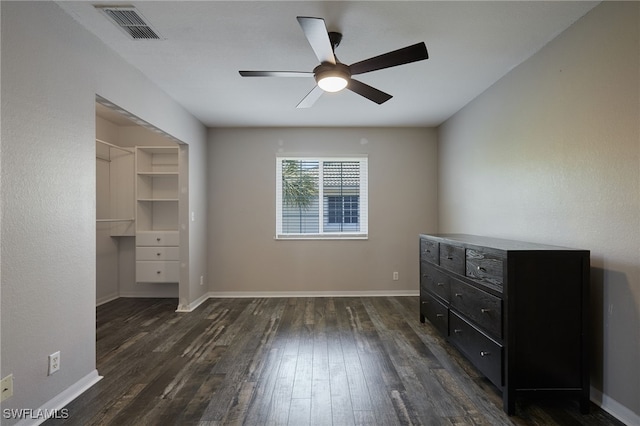 bedroom with dark wood-style flooring, visible vents, and baseboards