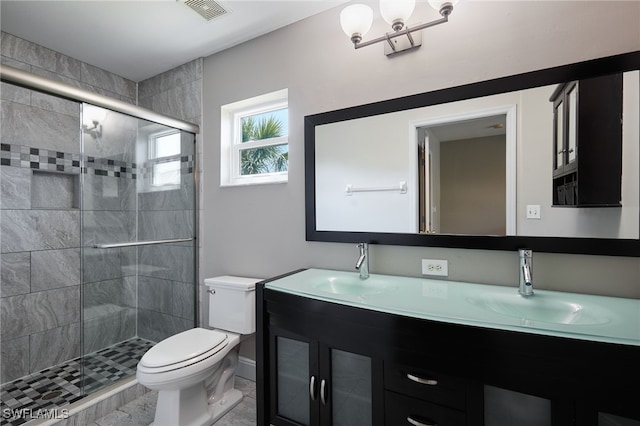 bathroom with a stall shower, visible vents, a sink, and toilet