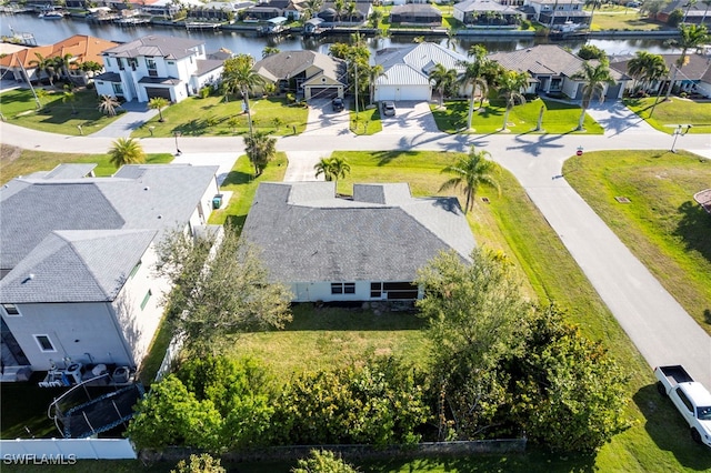 drone / aerial view featuring a residential view and a water view