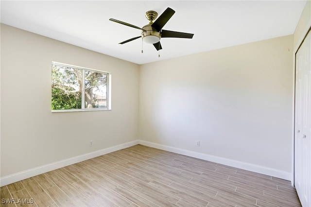 empty room featuring light wood-style flooring, baseboards, and ceiling fan