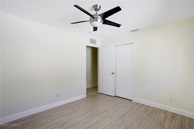 unfurnished bedroom featuring light wood-style floors, visible vents, and baseboards